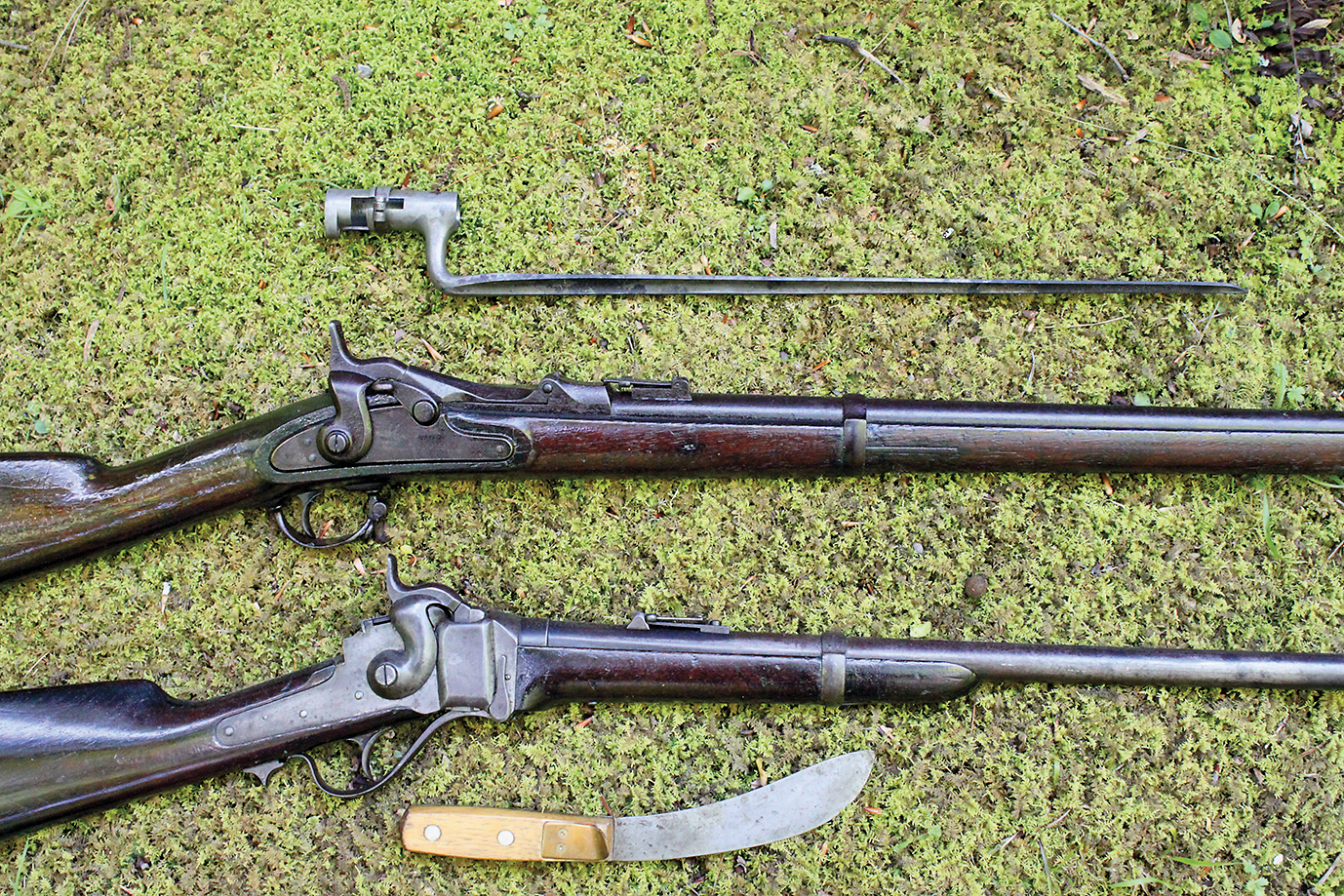 close up of the 2 50-70 rifles with vital necessities_scaled